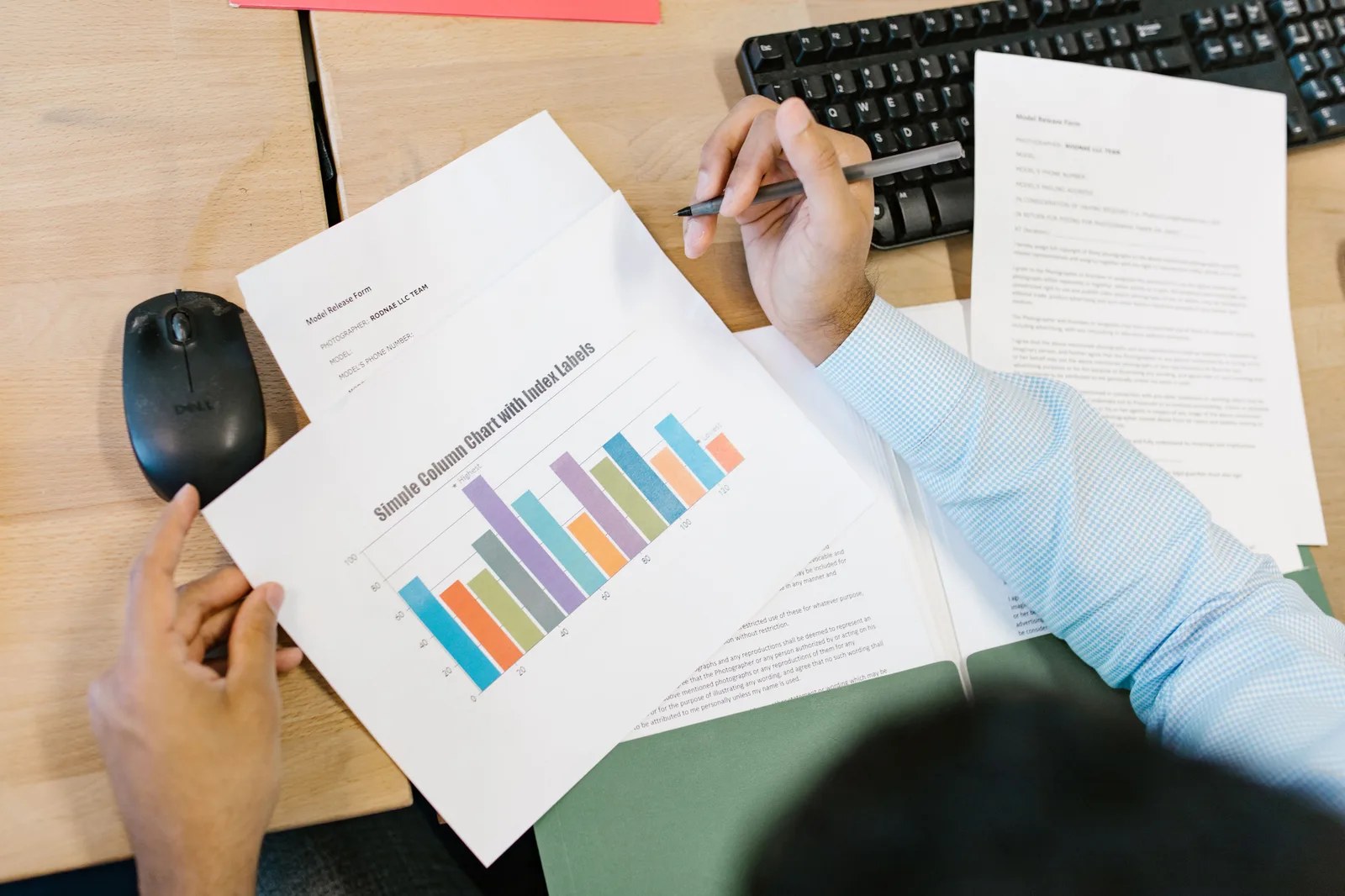 A business analyst reviews a colorful bar chart and documents at a desk, indicating data analysis. How to improve programmatic advertising for business teams: the parts worth your time